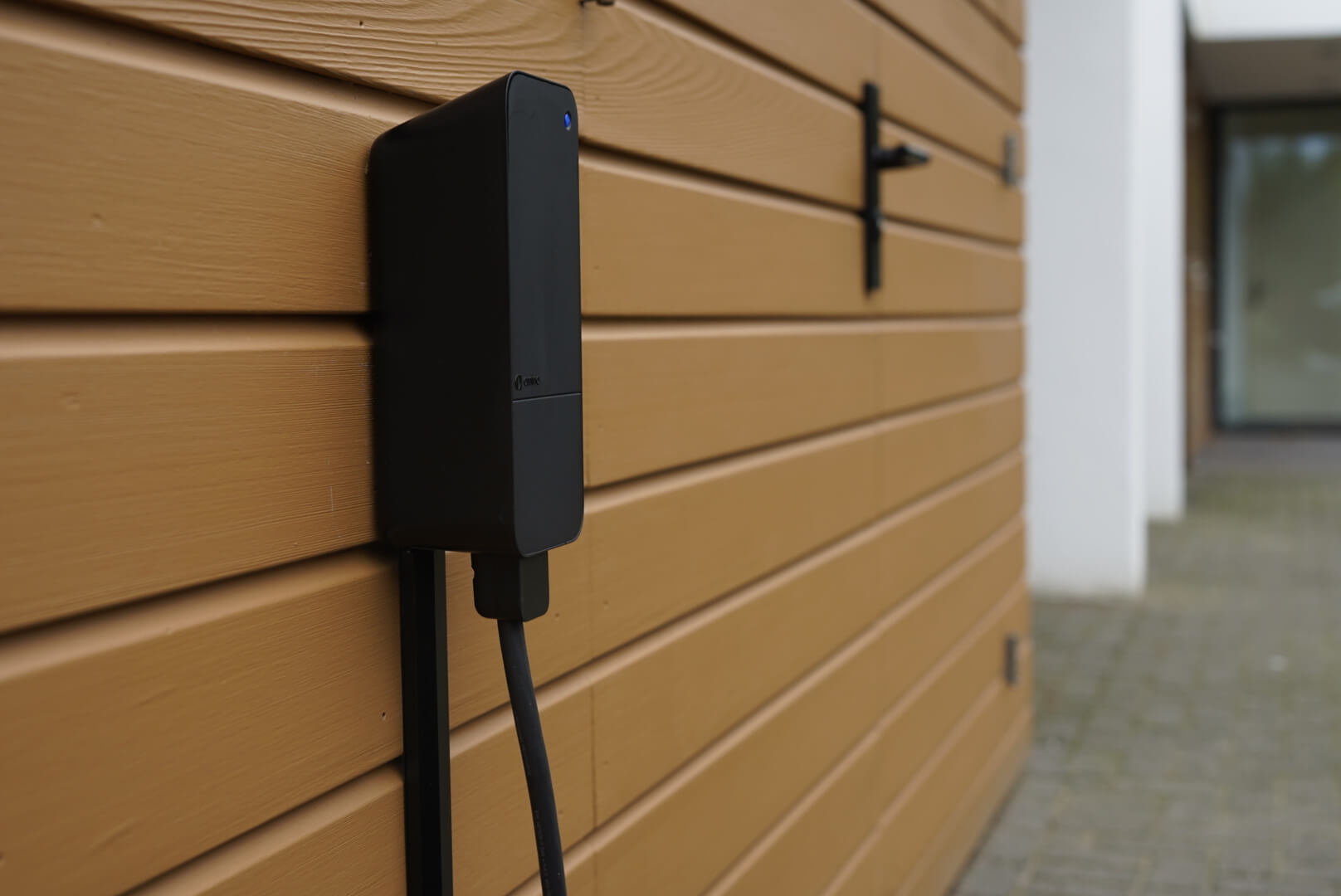 An amina S charger mounted on the wall